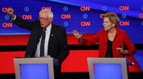 Sen. Bernie Sanders, I-Vt., and Sen. Elizabeth Warren, D-Mass., talk during in the first of two Democratic presidential primary debates hosted by CNN Tuesday, July 30, 2019, in the Fox Theatre in Detroit. (Paul Sancya/AP)