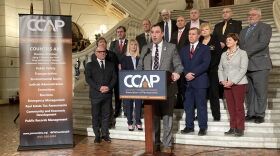 County Commissioner Association of Pennsylvania President Chip Abramovic, flanked by other county commissioners, speaks at a press conference in Harrisburg on Jan. 25, 2023.