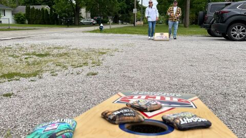 Frank Geers and Fin Walter play cornhole outside of the ACO headquarters in Camp Dennison. Geers says the org played a big role in 'professionalizing' the sport.