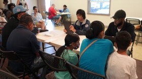 FEMA personnel helps survivors register for assistance during Hurricane Ian.