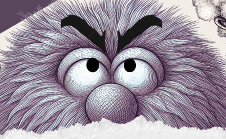 The top of a face of a shaggy puppet with big eyeballs looking up.