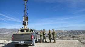 FILE - Army soldiers look at the border wall next to a surveillance vehicle in Sunland Park, N.M., Feb. 3, 2025. (AP Photo/Andres Leighton, File)