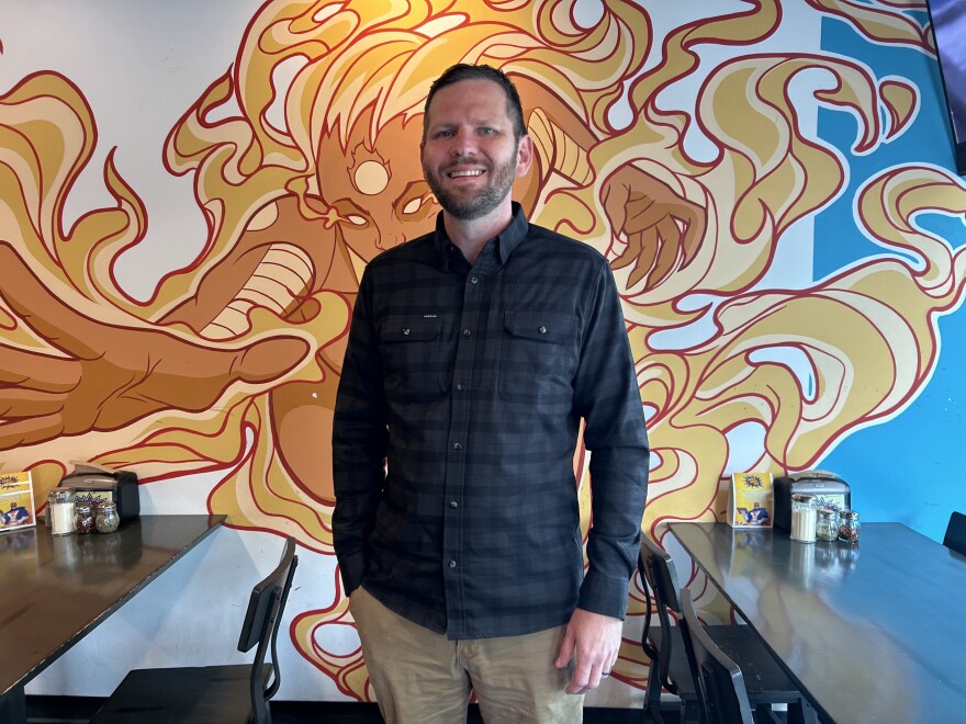 Commissioner Jeremy Matlow stands in a pizza restaurant. 