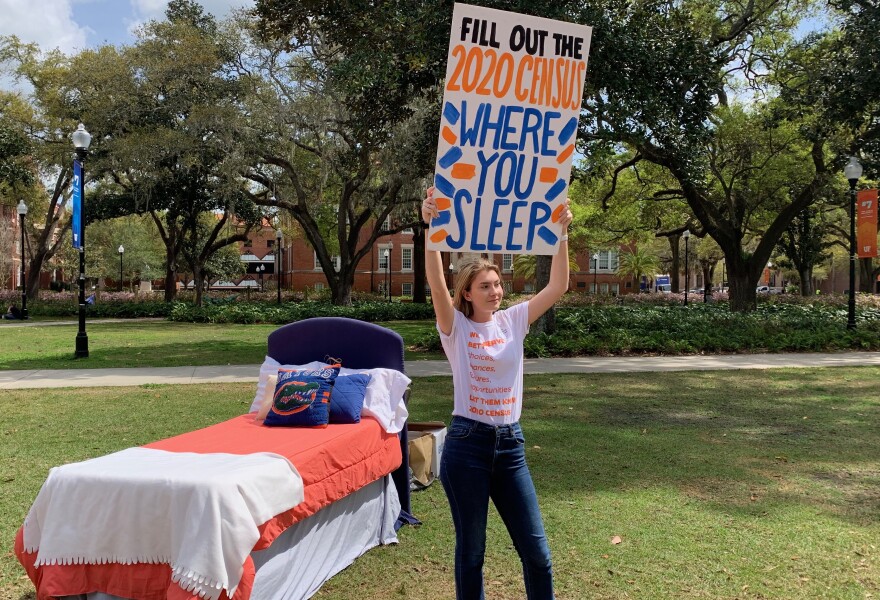 Carly Rogers, the UF Bateman team’s community outreach coordinator, holds a sign urging students to answer the census at UF’s Plaza of the Americas on March 11. The team’s “Where Do You Sleep” census promotion event highlighted that students should fill out the census with the location they sleep for most of the year. (Maya Punjwani/WUFT News)