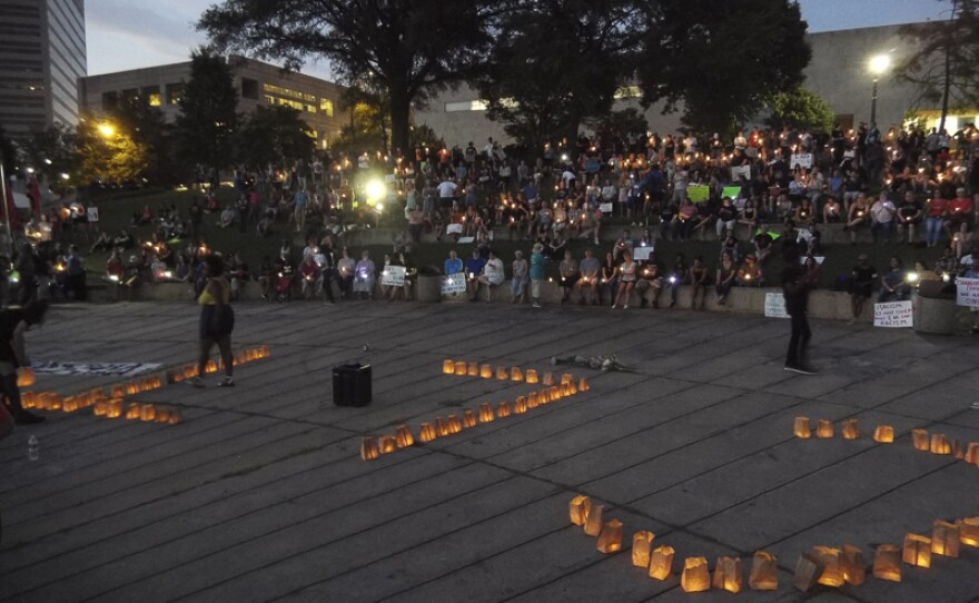 Several hundred people joined a Charlotte Uprising vigil Saturday night uptown. 