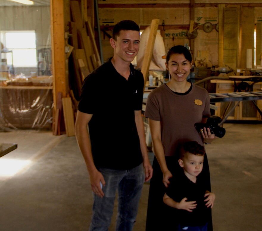 Isaiah Miller (left) with sister-in-law Sara and her son Sebastian in Teaberry woodworking shop in Shipshewana, Indiana