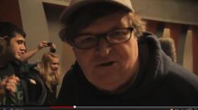 Filmmaker Michael Moore encourages Occupy Buffalo to hang in during winter time