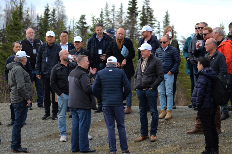 A group stands on a bluff at the proposed site of the Alaska LNG Project's export facility on Monday, May 18, 2026 in Nikiski, Alaska.