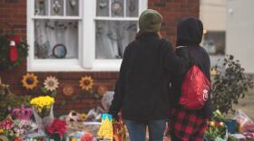 A woman comforts her friend outside of the Cookie Cottage in Norman where friends and customers of the owner, Shannon Hanchett, placed flowers, candles and cards following her death. Hanchett was was experience mental health issues when Norman police arrested her on Nov. 26 for making false reports to 911 and resisting arrest. On Dec. 8, Hanchett was found not breathing in a cell at the Cleveland County Detention Center where she was being held on a $1,000 bond. (Whitney Bryen/Oklahoma Watch)