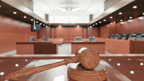 Looking at a gavel on the judge's bench into the courtroom