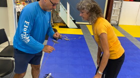  Coach Daniel Bucur and fencer Georgina Love discuss work he's done on her foil at Space Coast Olympic Fencing in Melbourne last week.