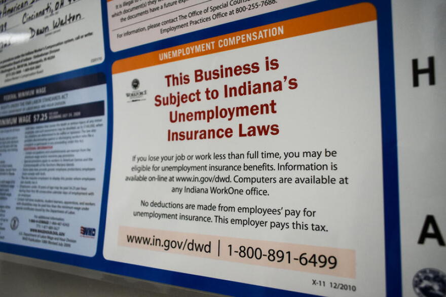 A public notice inside a human resources office stating it is subject to Indiana's unemployment insurance laws.