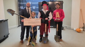 Dean Pettinato, director of the Scranton School for Deaf & Hard-of-Hearing Children, and some of the school's students pose for a photo during an event to mark the start of renovations for a wellness center.