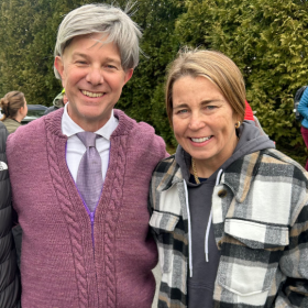 Monte Belmonte, dressed as Mister Rogers, stands with Governor Maura Healey and NEPM President Matt Abramovitz at the 16th annual March for the Food Bank.