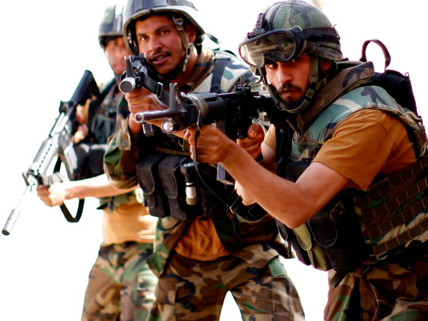 Afghan commandos work on clearing a mock house during a training session conducted by the U.S. Army Special Forces at Fire Base Thomas in western Afghanistan.