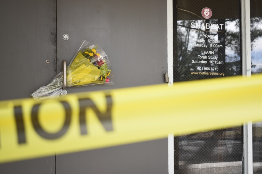 Caution tape and flowers cover the entrance to the Beth Israel Congregation, a synagogue that was set on fire early Saturday morning, on Monday, Jan. 12, 2026, in Jackson, Miss. 