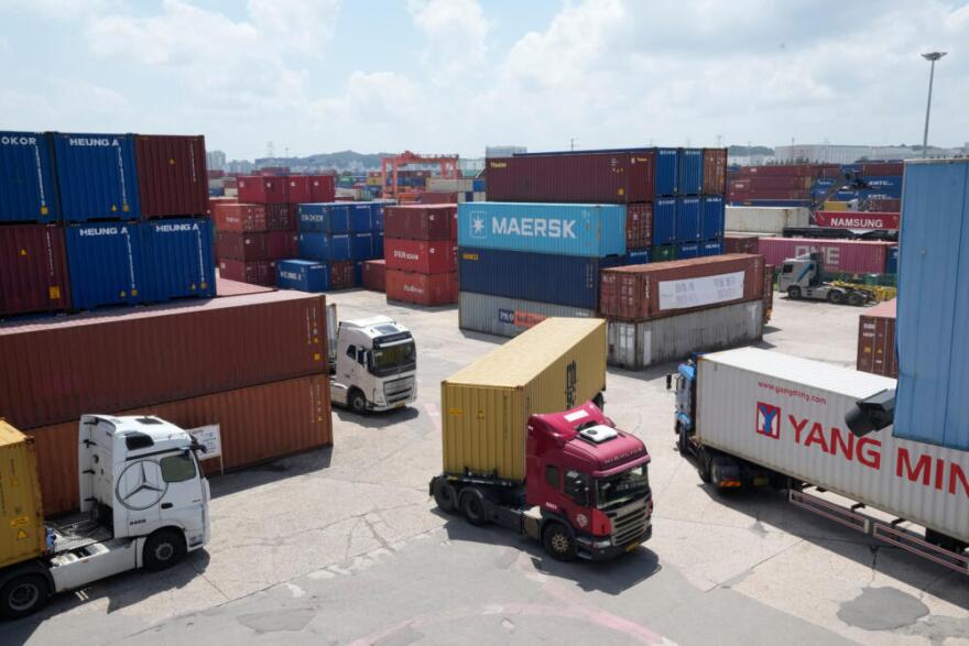 Trucks run by containers at an Inland Container Depot (ICD) terminal in Uiwang, South Korea, Friday, July 24, 2026. (Ahn Young-joon/AP)