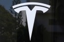 FILE - The Tesla logo is displayed at a Tesla dealership Thursday, Mar. 13, 2025, in Miami.