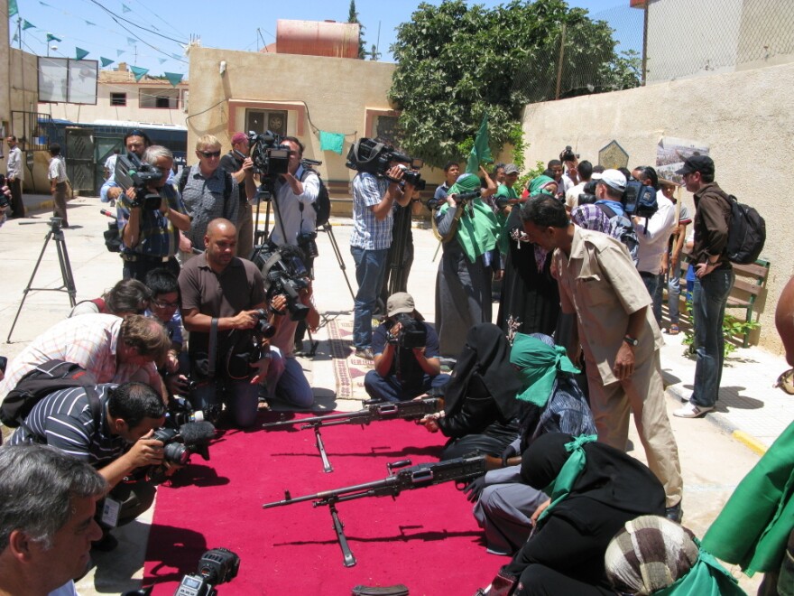 Reporters outnumber women who are showing their weapons expertise at a small  pro-Gadhafi demonstration in the mountain city of Gharyan, a key target for rebels who are trying to advance  toward Tripoli.