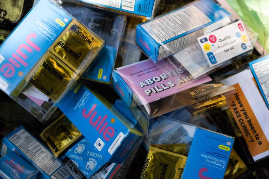 Condoms, sexual health literature and emergency contraception are prepared for kits by DePaul University students at Oz Park in Chicago on Sunday, Sept. 28, 2025.(Heidi Zeiger/AP)