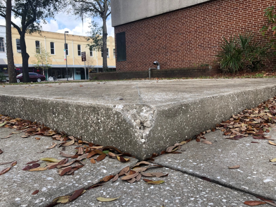 This 12-by-12 slab of concrete where the controversial statue of a Confederate soldier once stood outside the county administration building in downtown Gainesville remains empty. The county has put out a $40,000 call for artists to come up with a replacement artwork. (Steven Wolf/WUFT News)