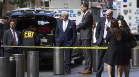 NYPD Deputy Commissioner of Intelligence & Counterterrorism John Miller, center, arrives outside Time Warner Center on Wednesday, Oct. 24, 2018, in New York. Law enforcement officials say a suspicious package that prompted an evacuation of CNN's offices is believed to contain a pipe bomb. (AP Photo/Kevin Hagen)