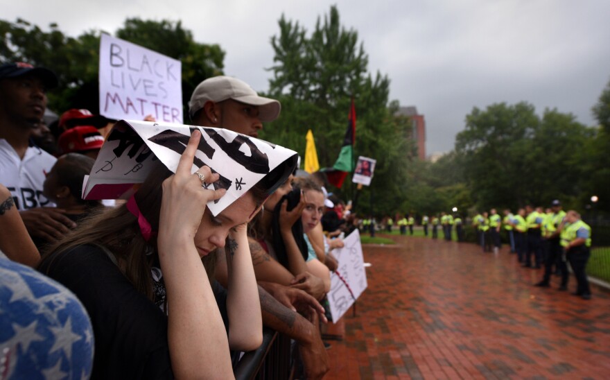 Police officers control a crowd of counter-demonstrators during a white nationalist-led rally.