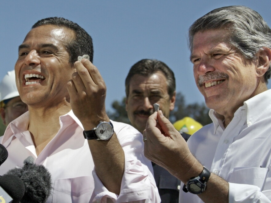 Los  Angeles Mayor Antonio Villaraigosa (left) and Los Angeles County  Supervisor Zev Yaroslavsky hold souvenir concrete chips as they  celebrate the demolition of two lanes of the Mulholland Drive bridge  over I-405 ahead of schedule Sunday.