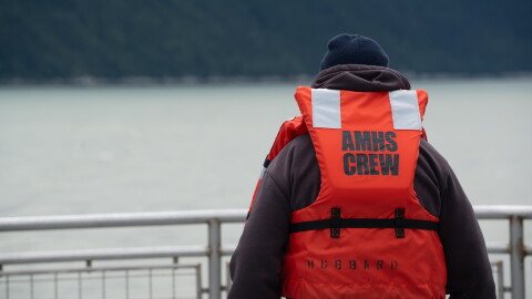 An Alaska Marine Highway System deckhand wears a life jacket labeled for crew use during an emergency drill aboard the ferry Hubbard on July 24, 2024. 