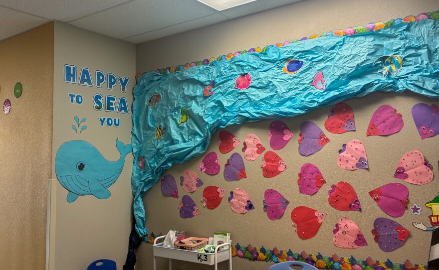 A sea-themed display outside Ms.Burge's class showcases happy heart-shaped fish.