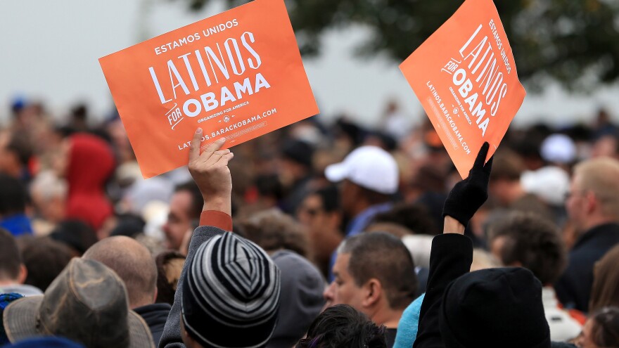 Latino supporters hold up signs as they attend a campaign rally for President Obama at Sloan's Lake Park in Denver on Oct. 4.