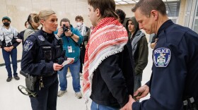 Michigan State University police arrest Eli Folts for trespassing. Folts is one of 19 pro-Palestine protesters arrested after occupying the first floor of the Hannah Administration Building for more than two hours on April 10, 2025. The group was given three warnings before police began making arrests.