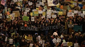 Demonstrators hold a banner reading "Climate Justice" during a mass climate march to demand action on the climate crisis from world leaders attending the COP25 summit. (Gabriel Bouys/AFP/Getty Images) 