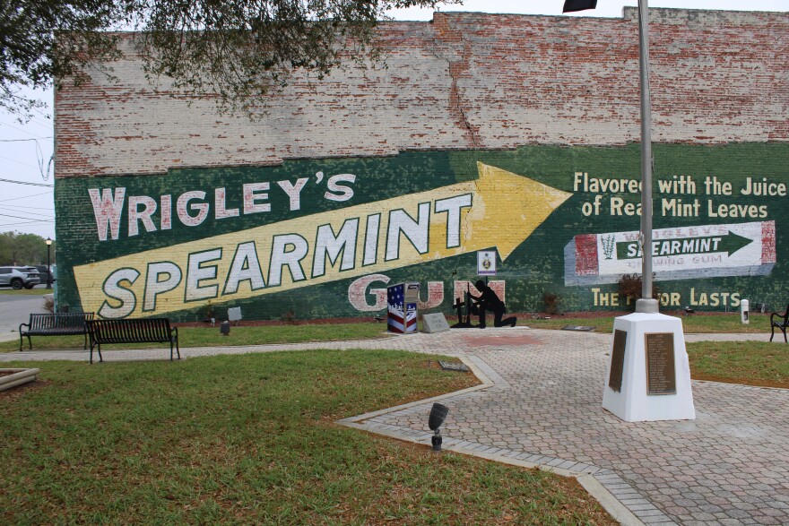 A mural advertising Wrigley’s gum in downtown Live Oak bears a waterline from hurricane flooding in 2024.