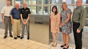 Pekin City Council members (from left) Rick Hilst, Dave Nutter, John Abel, Mayor Mary Burress, Karen Hohimer and Jake Fletcher stand Monday with the Pekin time capsule in the city hall lobby that will be opened July 4, 2076. Mayor Pro-Tem Peg Phillips was not at the council meeting.