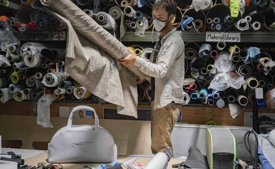 Nick Rubalcava prepares a silver-coated, metalized, nonwoven fabric for filter trials on a new mask concept.