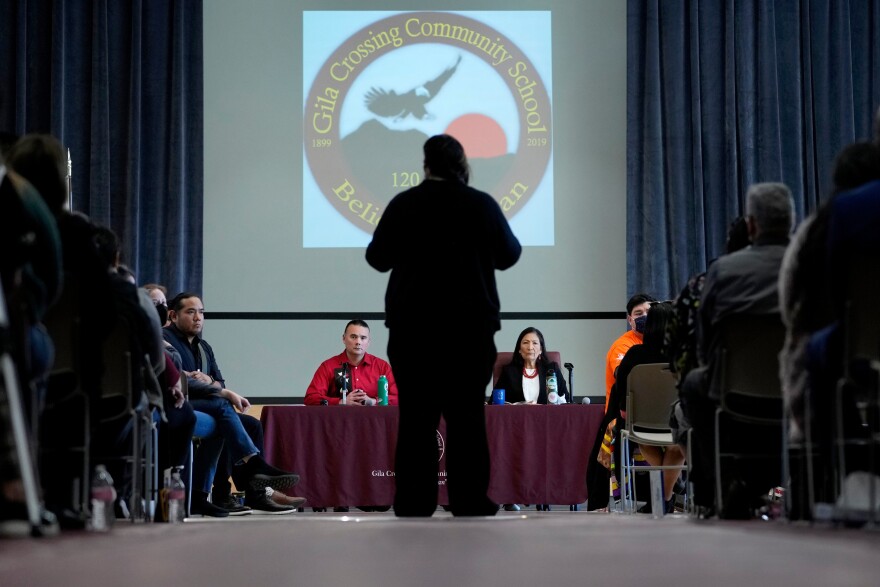 FILE - U.S. Interior Secretary Deb Haaland, right, and Assistant Secretary for Indian Affairs Bryan Newland, left, listen as April Hiosik Ignacio, center, speaks, Jan. 20, 2023, in Laveen, Ariz.