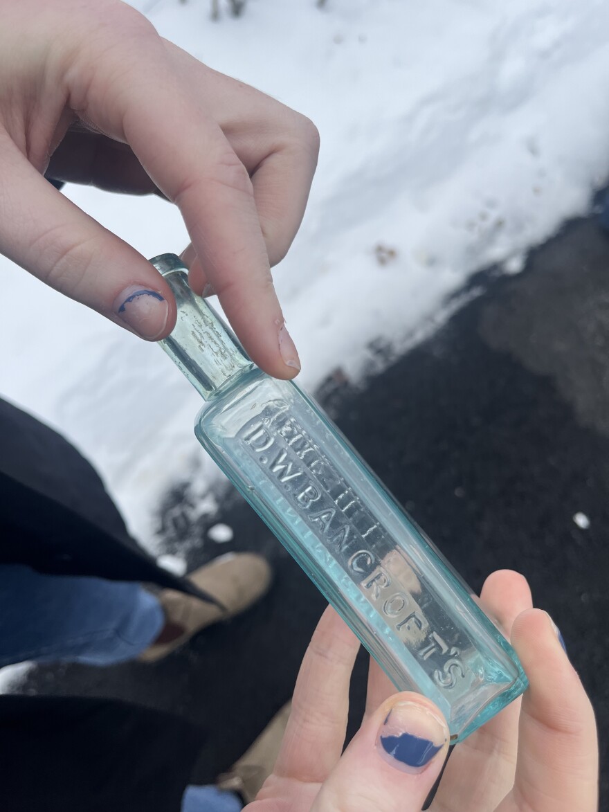 A blue glass bottle says "D.W. Bancroft's" on it.