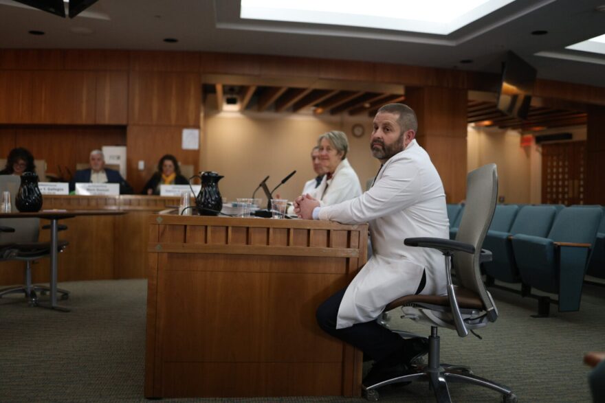 Four Las Cruces doctors, including Arthur Berkson, right, donned white coats to speak to an interim legislative committee in Santa Fe on Dec. 15, 2025. They urged the Legislature to reform the state’s medical malpractice and medical tax policies to retain and attract more physicians to the state. (Patrick Lohmann/SourceNM)