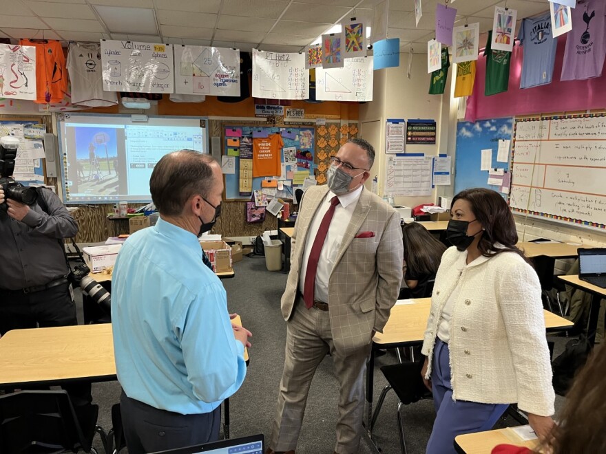 Rep. Norma Torres and Education Secretary Miguel Cardona speaking with a De Anza Middle School teacher (right to left).