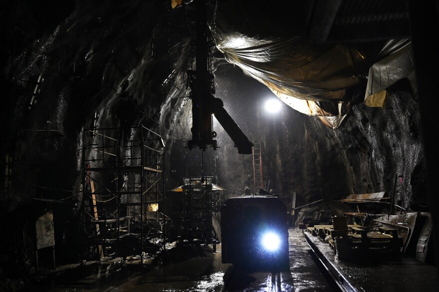 FILE: A delivery pipe for cement and grout hangs over locomotive tracks in the launch shaft of an MDC tunnel project that took place in Hartford, Connecticut July 29, 2021. The project was a 4 mile tunnel that was dug under Hartford and West Hartford to manage storm water.