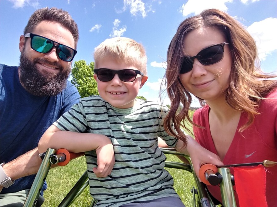 Kathryn and Tyler Atchley have been trying to spend as much time as possible outside with their 7-year-old son, Parker, since the pandemic began. Parker, who has a rare neurological condition, enjoys taking long walks with his parents.