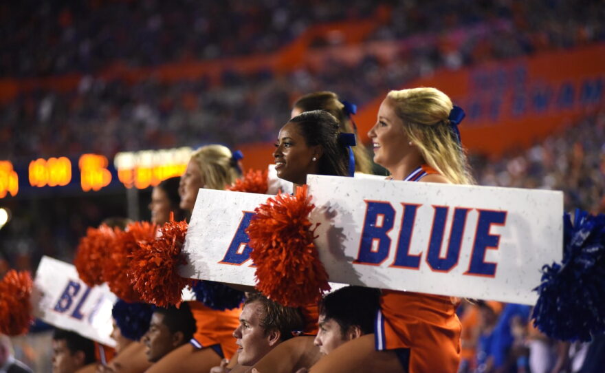 Cheerleaders lead the crowd in the Orange and Blue cheer.