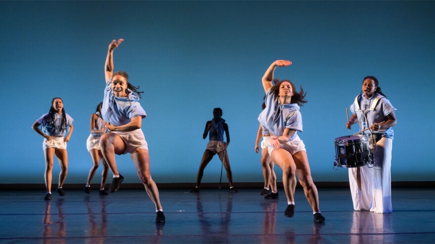 A photo of a group of women dancing on stage during an Urban Bush Women performance