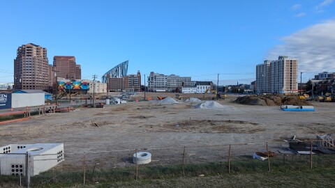 Undeveloped lots contain piles of dirt and construction equipment.