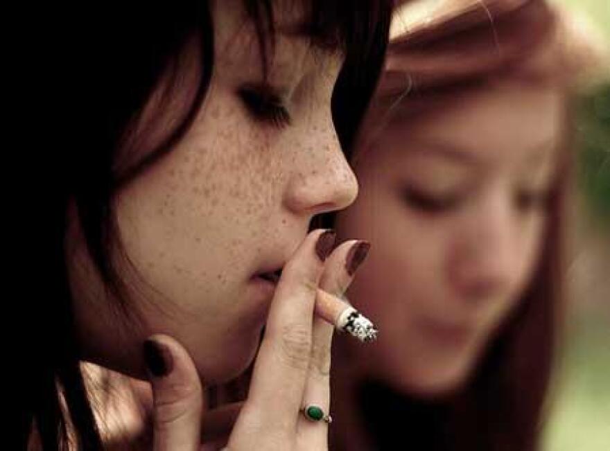 A picture of a girl smoking a cigarette.