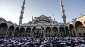 Turkish Muslims offer Eid al-Fitr prayers at the city's landmark Sultan Ahmed Mosque, or Blue Mosque, in Istanbul, early Sunday, June 25, 2017. Eid al-Fitr marks the end of the Muslims' holy fasting month of Ramadan. (Emrah Gurel/AP)