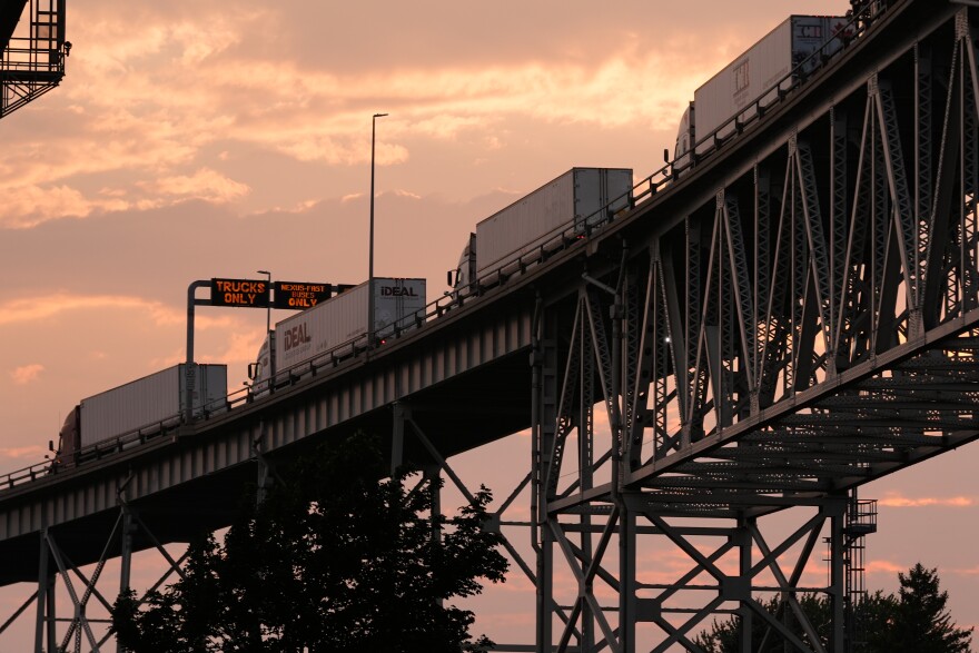 Semi-trucks wait in line to enter the United States in Port Huron, Mich., across the Blue Water Bridge from Sarnia, Ontario Monday, July 20, 2026.