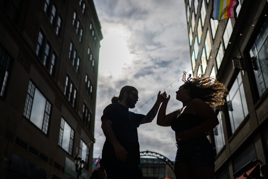 Salsa dancers Ricky MacPhail and Adriana Diaz dance on Pratt Street shortly before it was flooded with hundreds of Salsa dancers. For five Friday nights throughout the summer the Hartford Business Improvement District hosts free Pratt Street Salsa Socials open to the public. Closed to vehicles during the socials, organizer Chip McCabe said at times crowds read at close to 1000 people. Attendee Ricky Belizaire, said about the socials, “it's connection, it's community. And I think, like, especially like a time like this, we need more community. We need more of that.” (Mark Mirko/Connecticut Public)