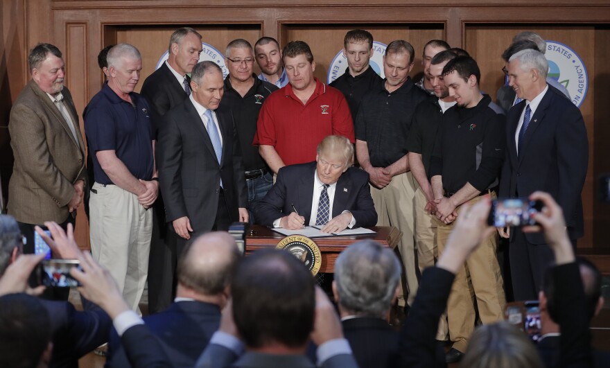 President Donald Trump signs an Energy Independence Executive Order on Tuesday at EPA headquarters in Washington.